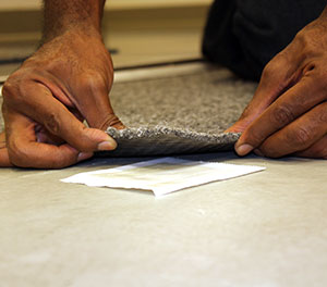 pressure sensitive adhesive application for carpet tiles
